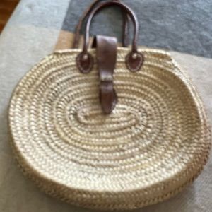 Round straw tote , leather handles